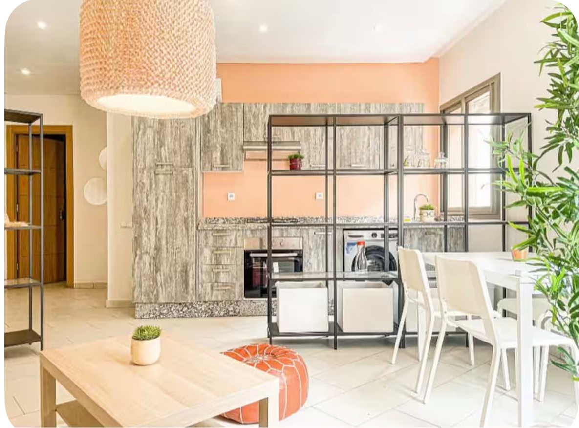Fully equipped kitchen with peach accent wall and dining area