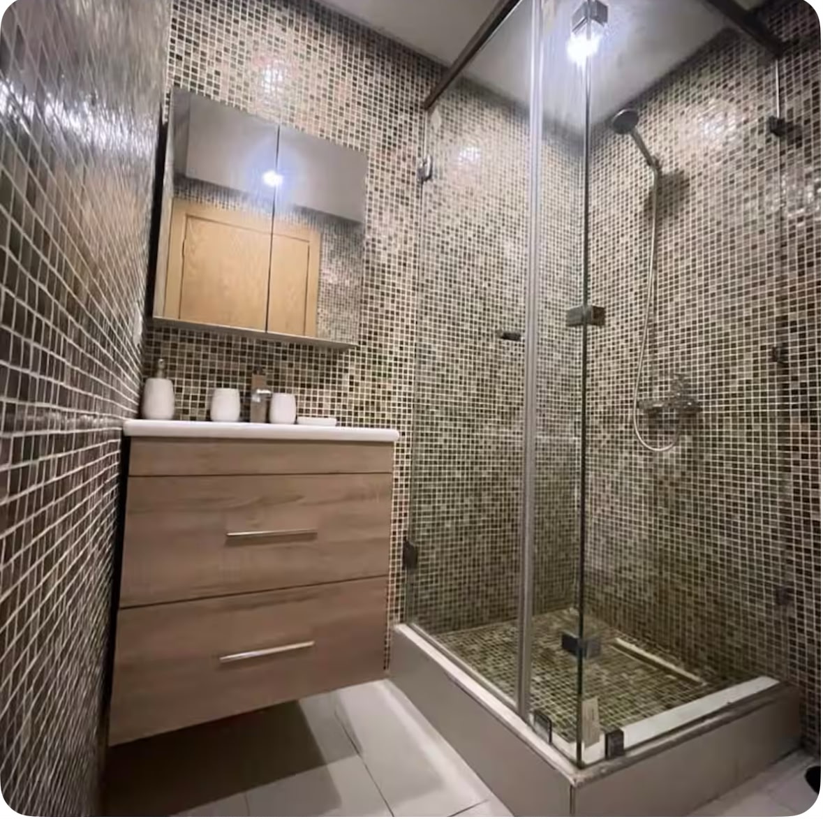 Bathroom with mosaic tilework and walk-in shower